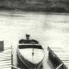 The old boat dock was located on the north side of the river just east of the present day bridge. The boat in the dock is also pictured to the right of this photograph